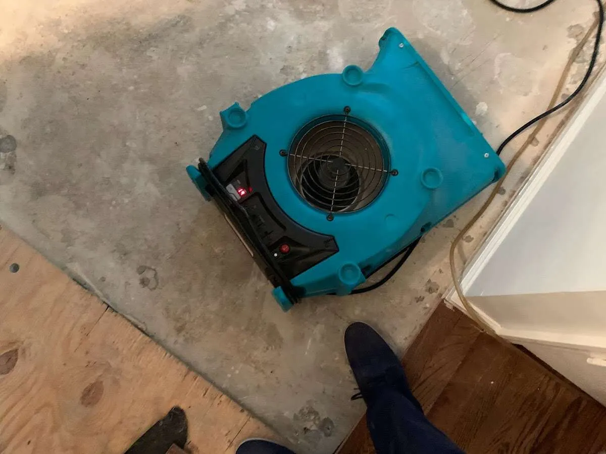 Air mover drying subfloor during Commercial Water Damage Restoration in Huntingburg
